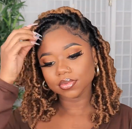 A women wearing a hand braided wig with ombre box braids, featuring a mix of dark and light brown colors.