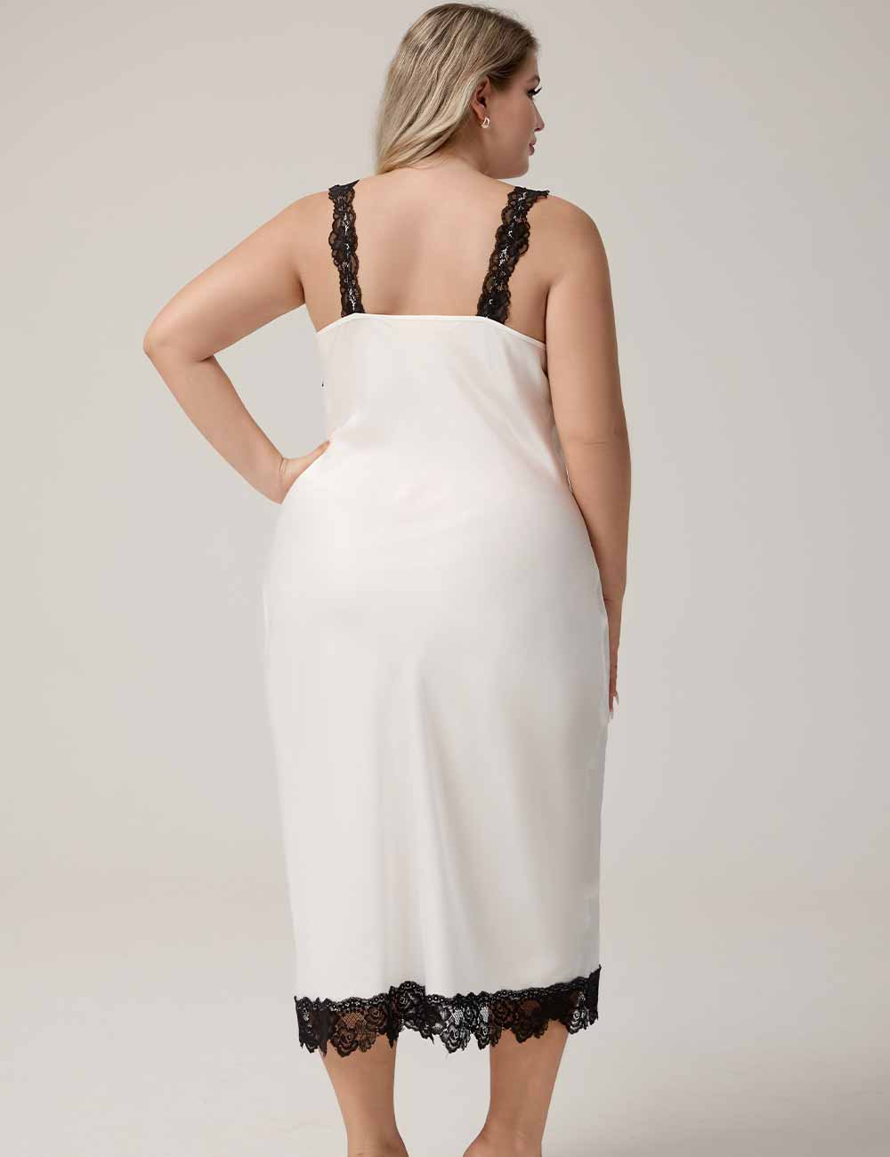 Woman wearing a white slip with black lace trim