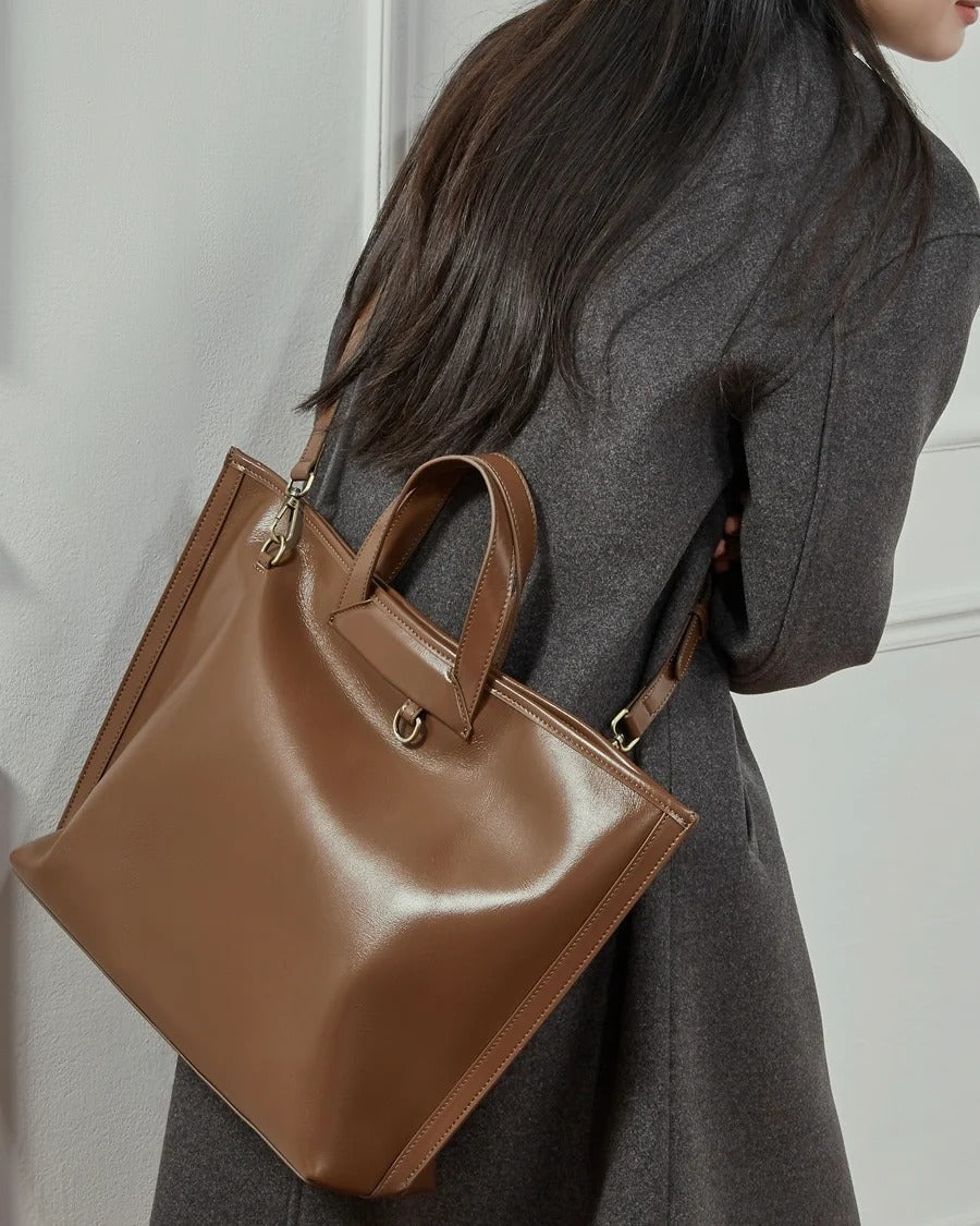 Brown handbag held by a person