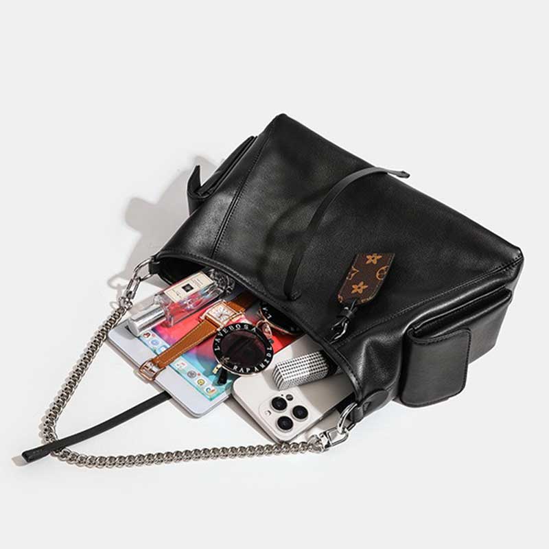 Black handbag with a chain strap containing various items