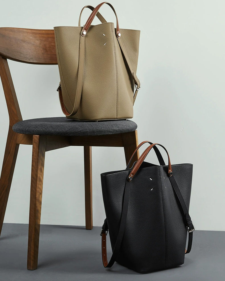 Two leather handbags, one gray and one black