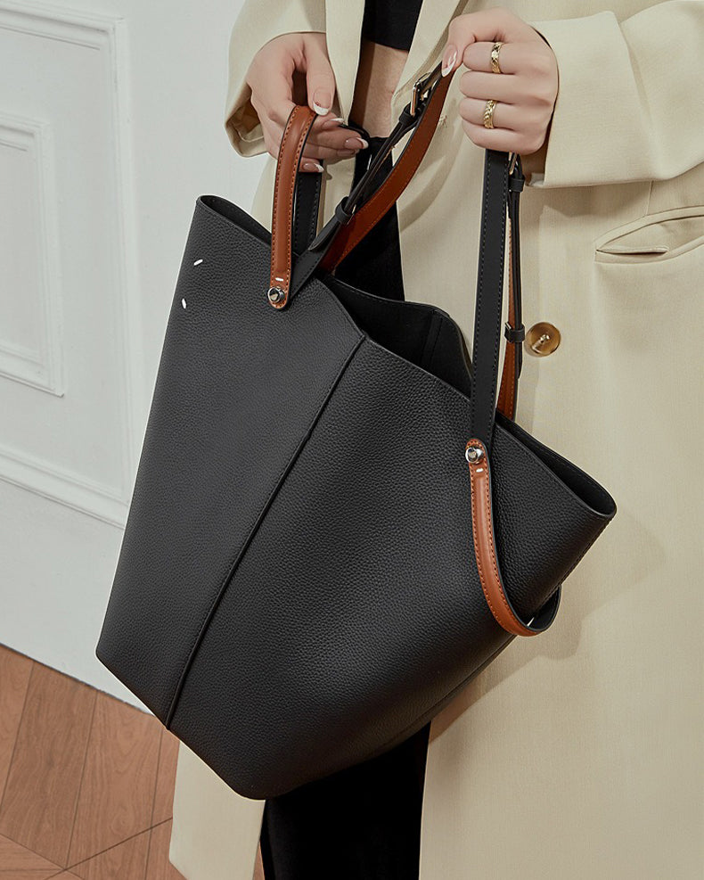 Person holding a black Large Capacity Bucket handbag