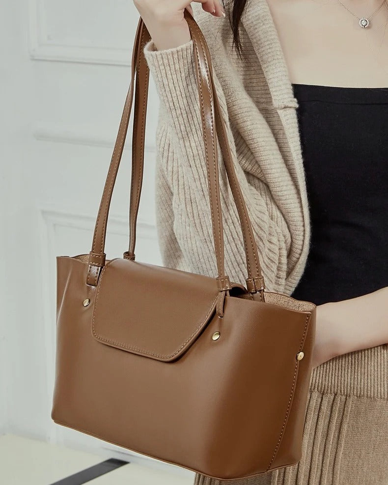 Brown handbag held by a person