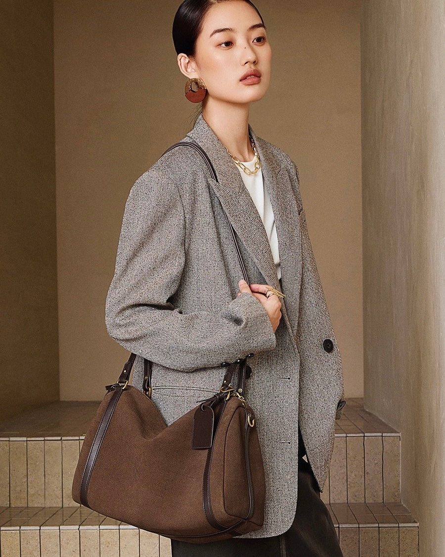 brown bag against a beige wall