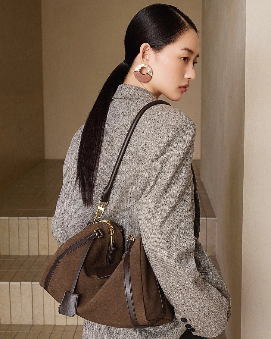 brown bag against a beige wall