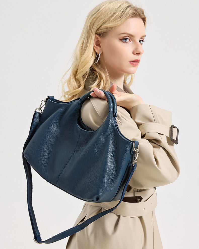 Woman holding a blue Genuine Leather handbag