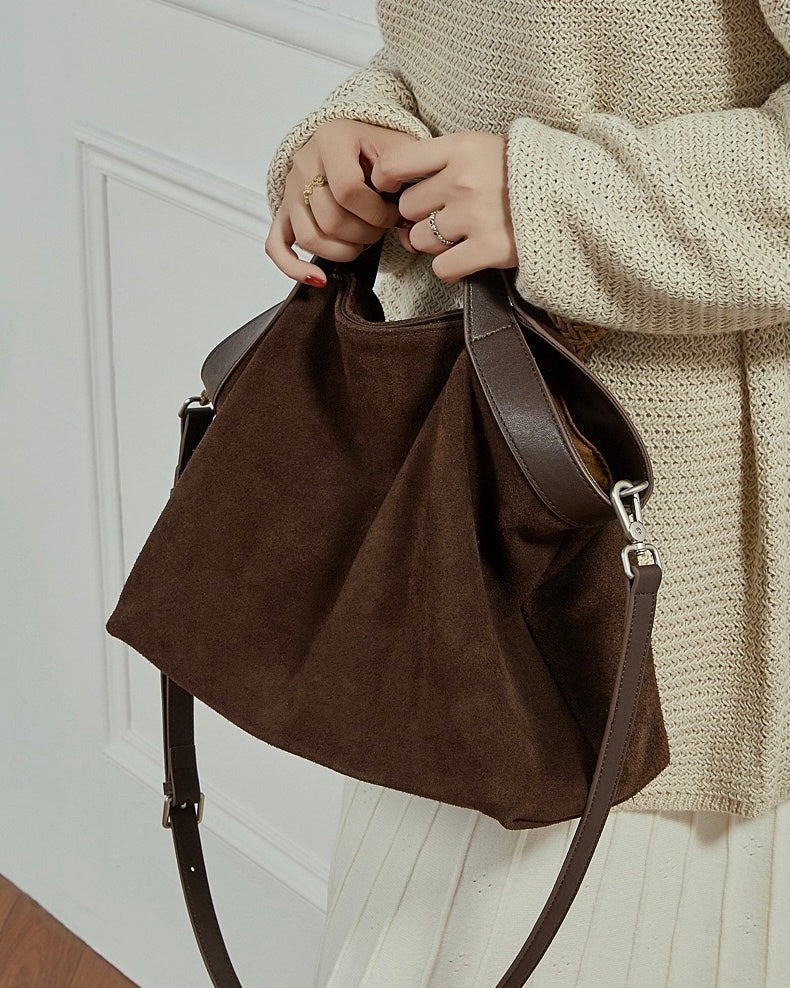 Coffee Brown handbag held by a person