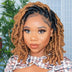 A women wearing a hand braided wig with ombre box braids, featuring a mix of dark and light brown colors.