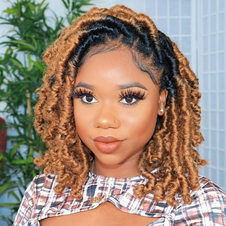 A women wearing a hand braided wig with ombre box braids, featuring a mix of dark and light brown colors.