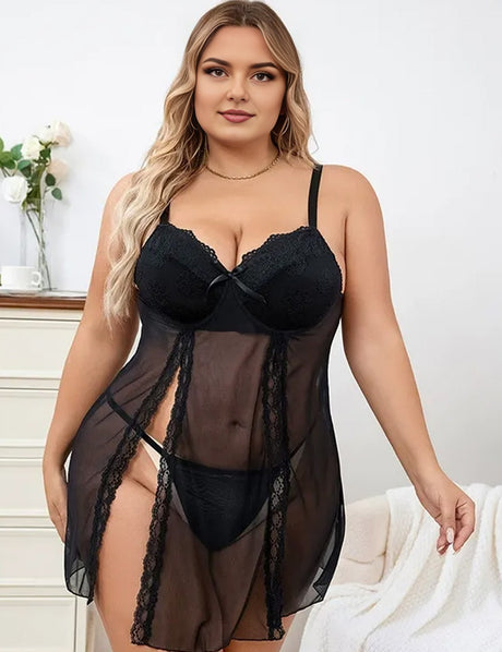 Woman wearing a black lace lingerie set against a white background