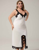 Woman wearing a white slip nightgown with black lace details
