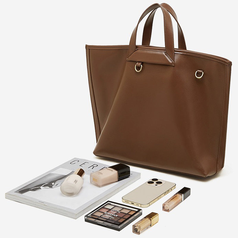 Brown tote bag with cosmetics and a phone 