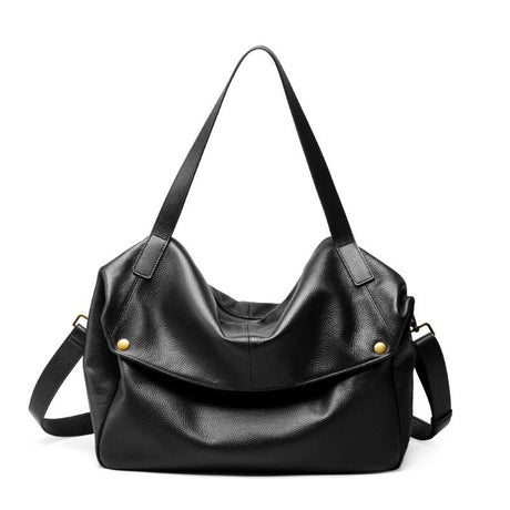Black leather handbag with gold hardware on a white background