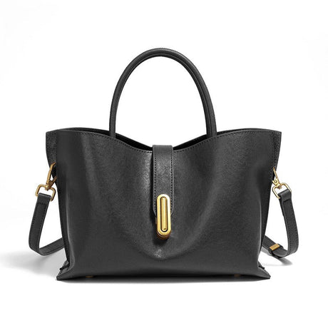 Black handbag with gold hardware on a white background