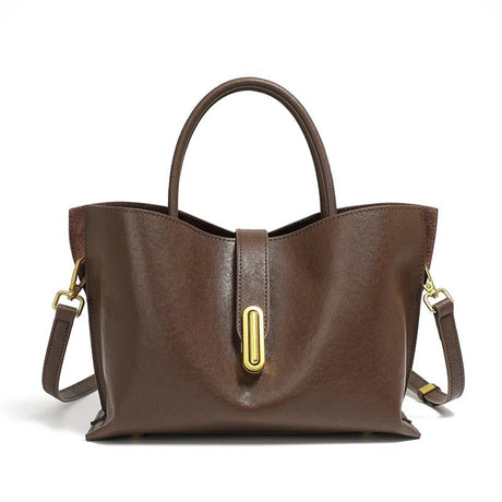 Coffee leather handbag with gold hardware on a white background