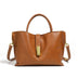 Brown leather handbag with gold accents on a white background