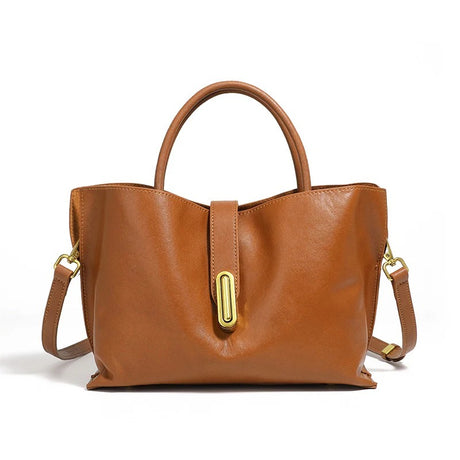 Brown leather handbag with gold accents on a white background
