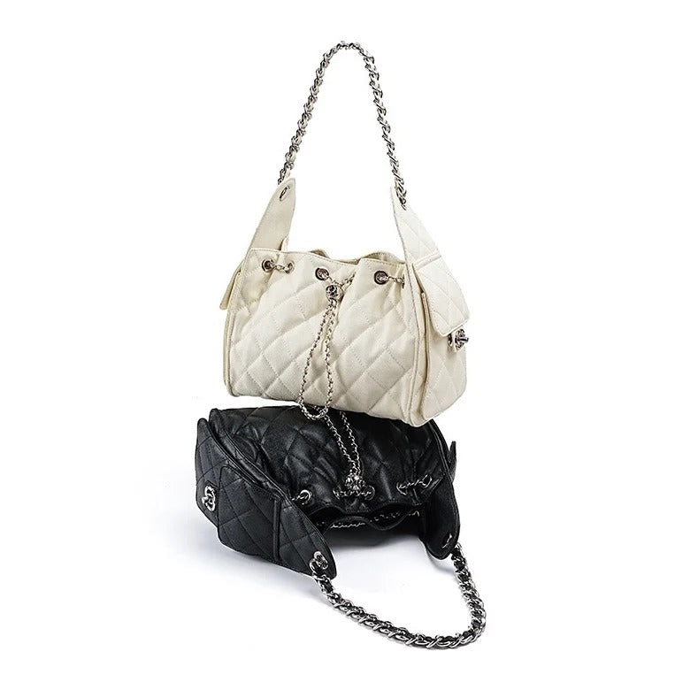 Two handbags, one off-white and one black, with chain straps