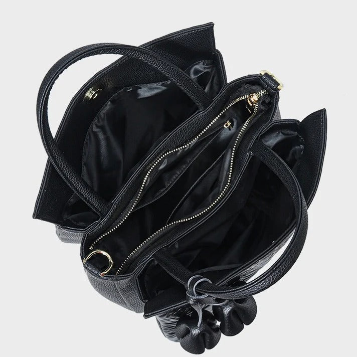 Black handbag with open top and visible interior 
