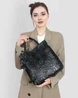 Woman holding a Cowhide Rose-Embossed Crossbody Tote Bag