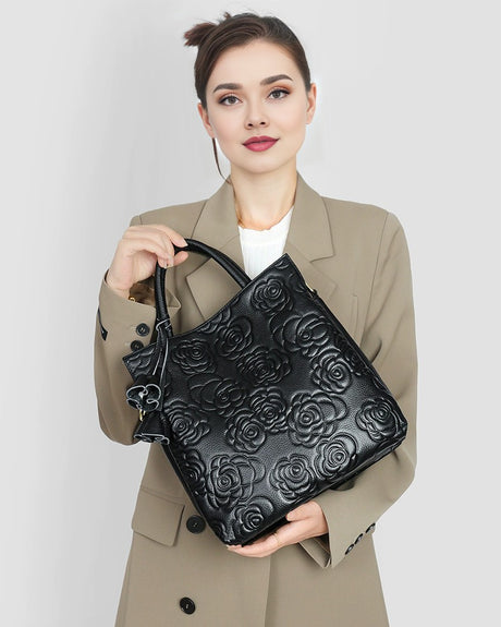 Woman holding a Cowhide Rose-Embossed Crossbody Tote Bag