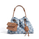 Blue checkered handbag with brown leather accents