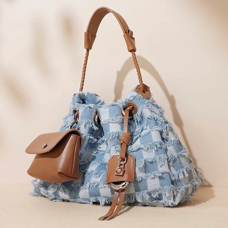 Blue denim handbag with brown leather accents