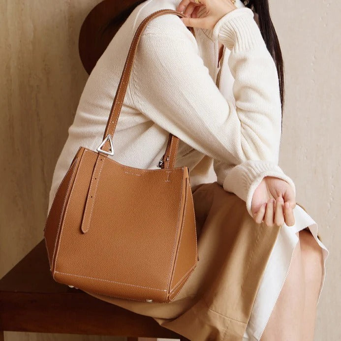 Person holding a brown Leather Geometric tote bag