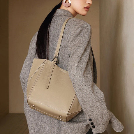 Woman carrying a gray handbag 