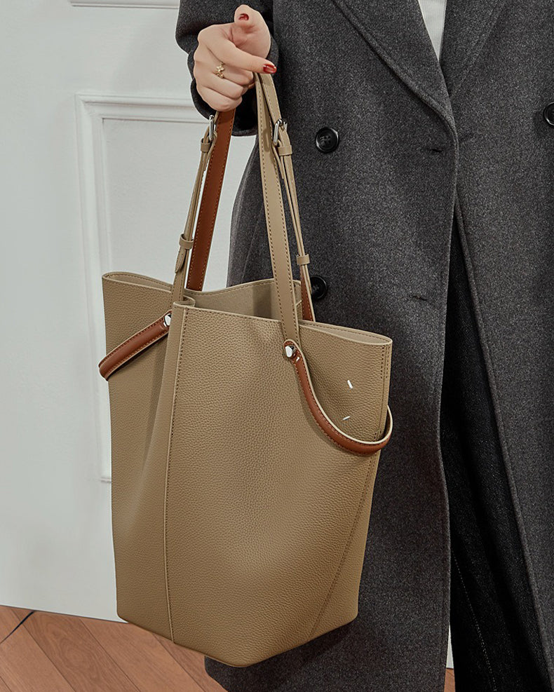 Person holding a gray Bucket bag 