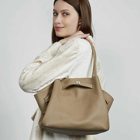Woman holding a gray handbag 