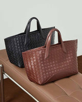 Two woven handbags, one black and one burgundy