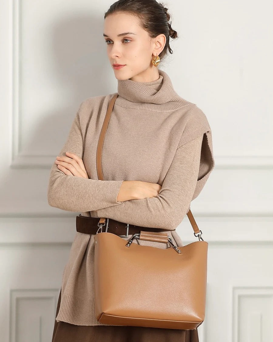 Woman holding a khaki Genuine Leather handbag with Metal Handle