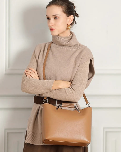 Woman holding a khaki Genuine Leather handbag with Metal Handle