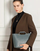 Woman holding a blue handbag 