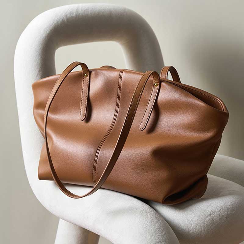 Genuine Leather Brown leather bag on a white chair