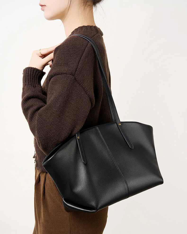 Person with a black leather handbag 