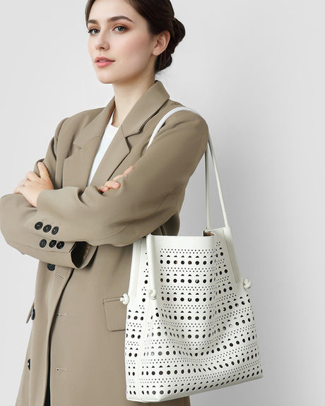 Woman holding a white Perforated handbag 