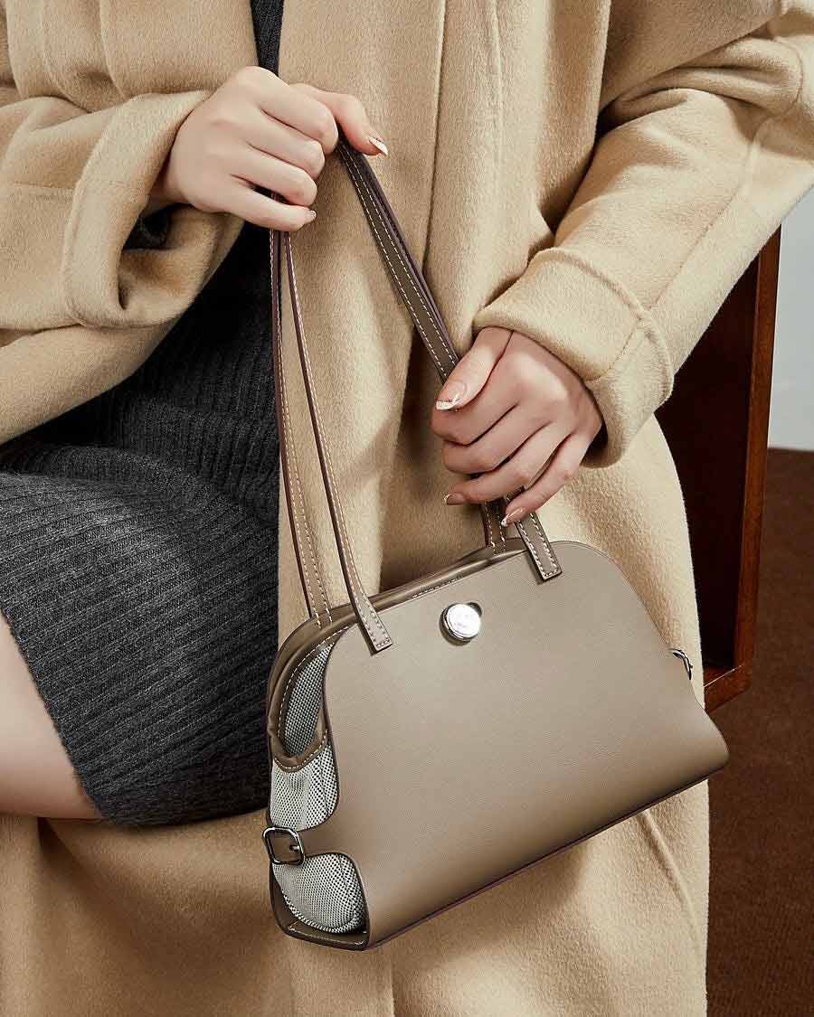 Person holding a gray Structured tote bag