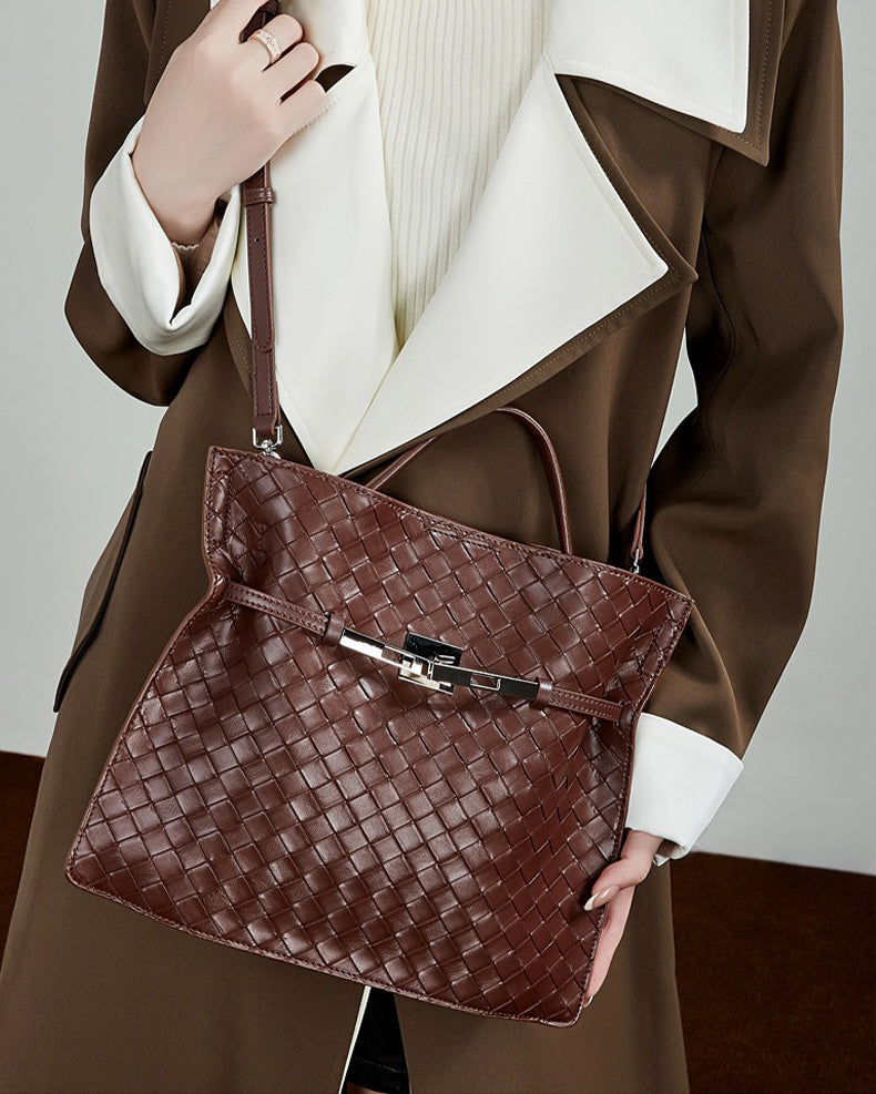 Brown woven handbag held by a person 