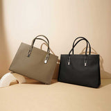 Two leather handbags, one gray and one black