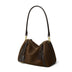 Brown handbag with black straps on a white background