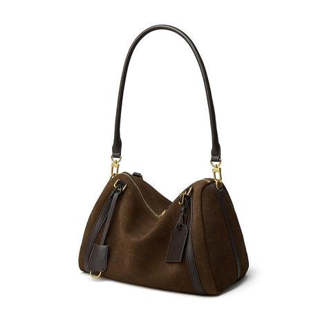 Brown handbag with black straps on a white background