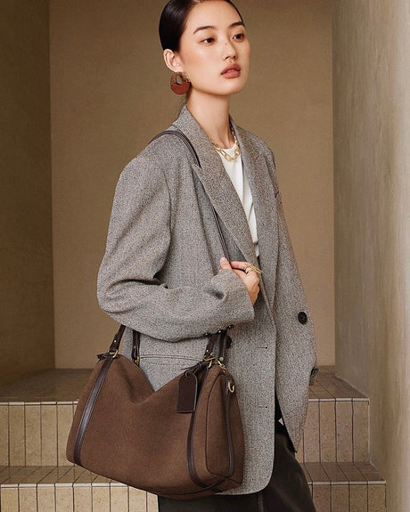  brown bag against a beige wall