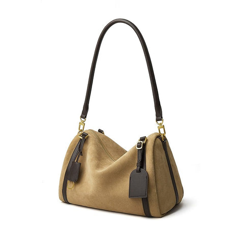 Beige handbag with black accents on a white background