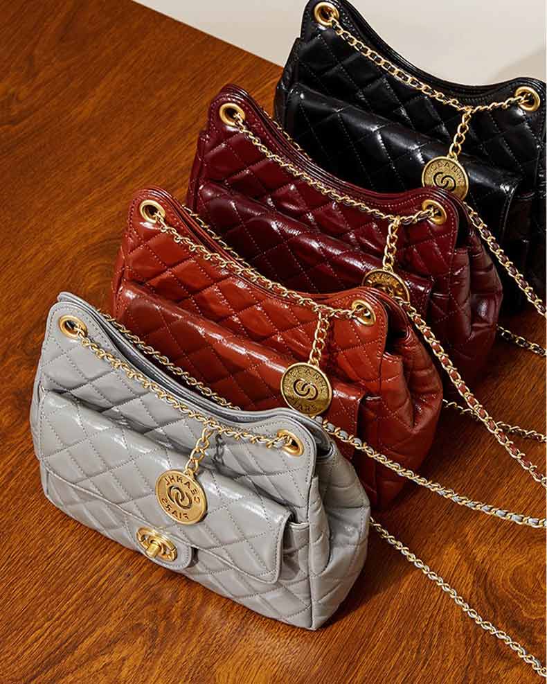 Four quilted handbags in gray, burdundy, caramel,and black with gold chains 