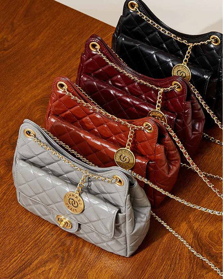 Four quilted handbags in gray, burdundy, caramel,and black with gold chains 