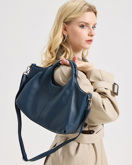 Woman holding a blue Genuine Leather handbag 