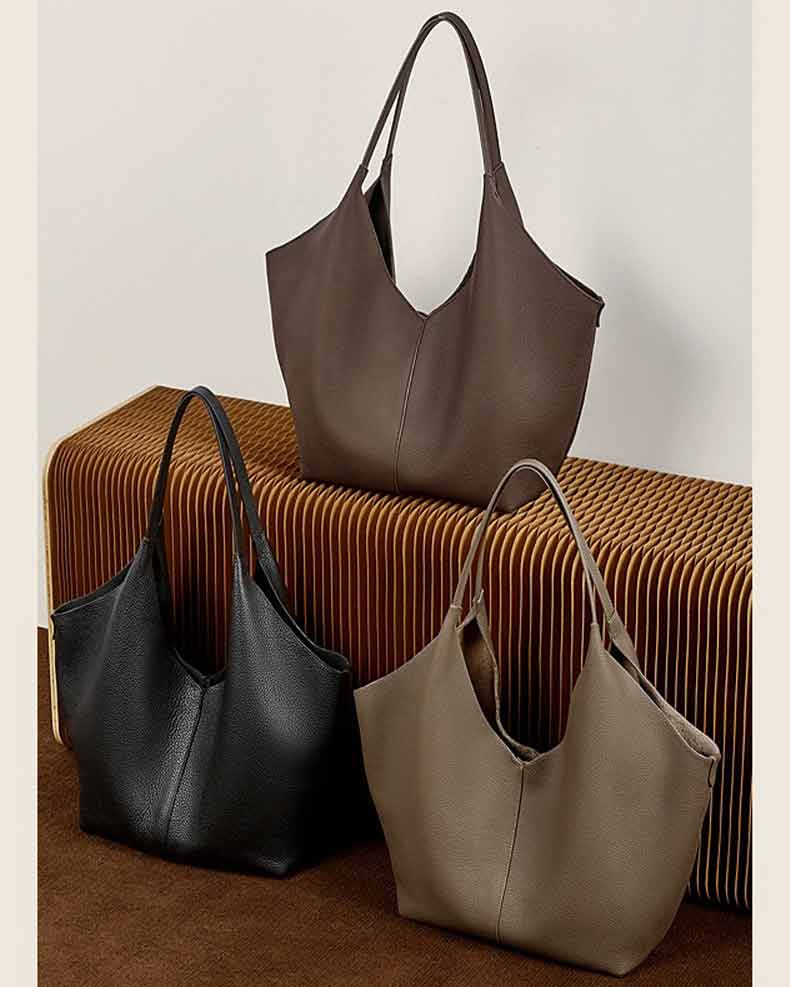 Three leather handbags in black, coffee, and gray