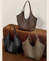 Three leather handbags in black, coffee, and gray